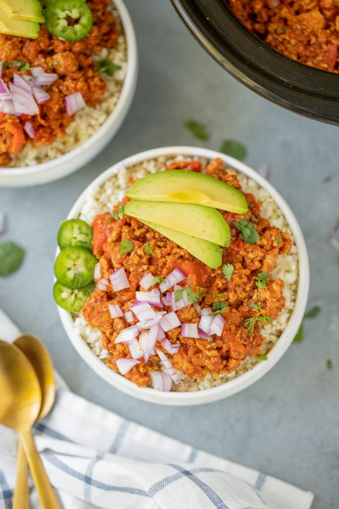 Paleo Turkey Chili in a grey background with a crockpot off to the side