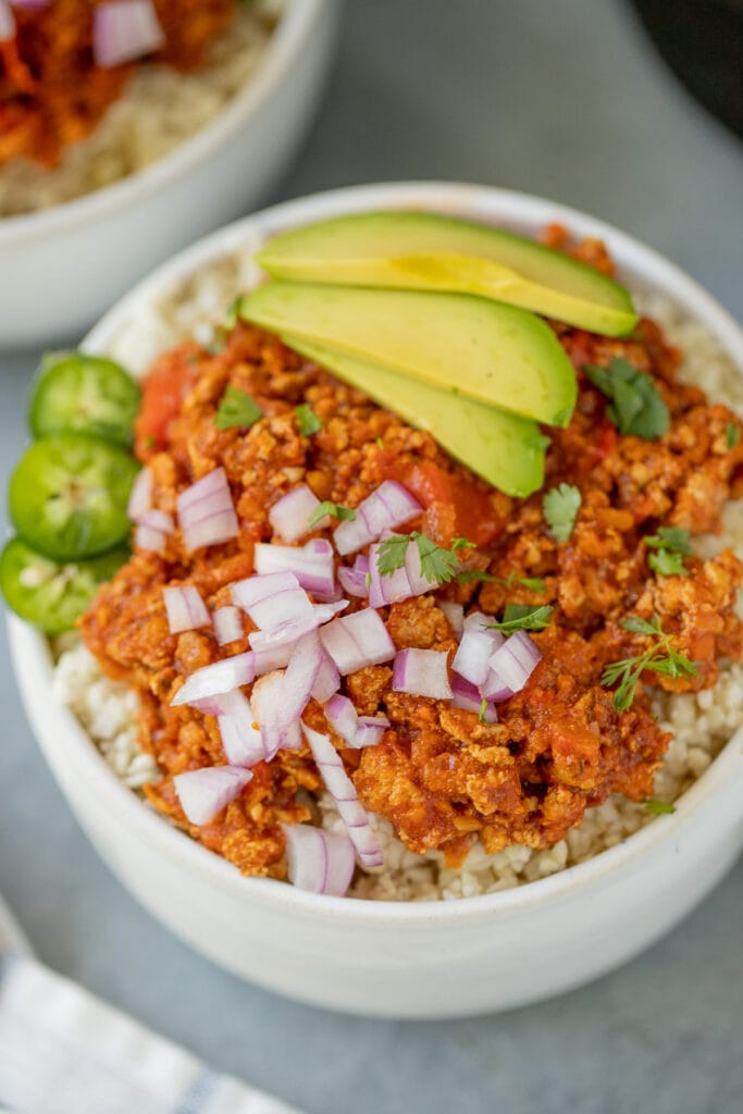 Healthy paleo turkey chili made in the slow cooker. an overhead shot of chili in small white bowls