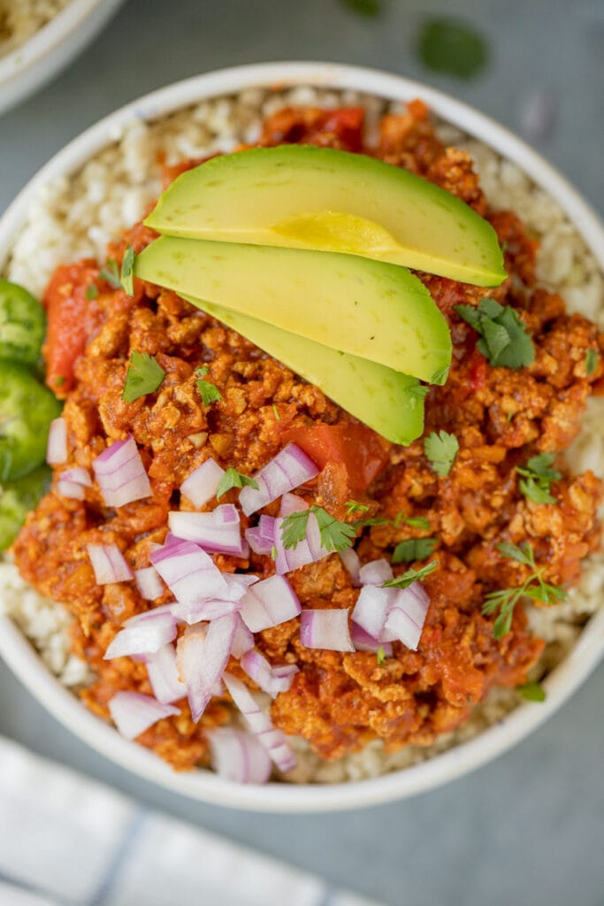 A close up of healthy turkey chili on a grey background