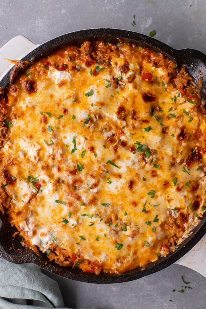 An overhead shot of unstuffed peppers skillet on a grey background