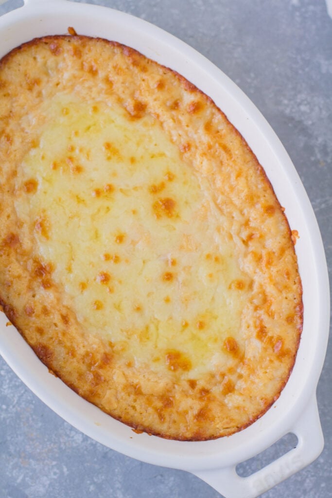 An overhead shot of Cheesy Vegetarian Buffalo Dip in a small oval bowl