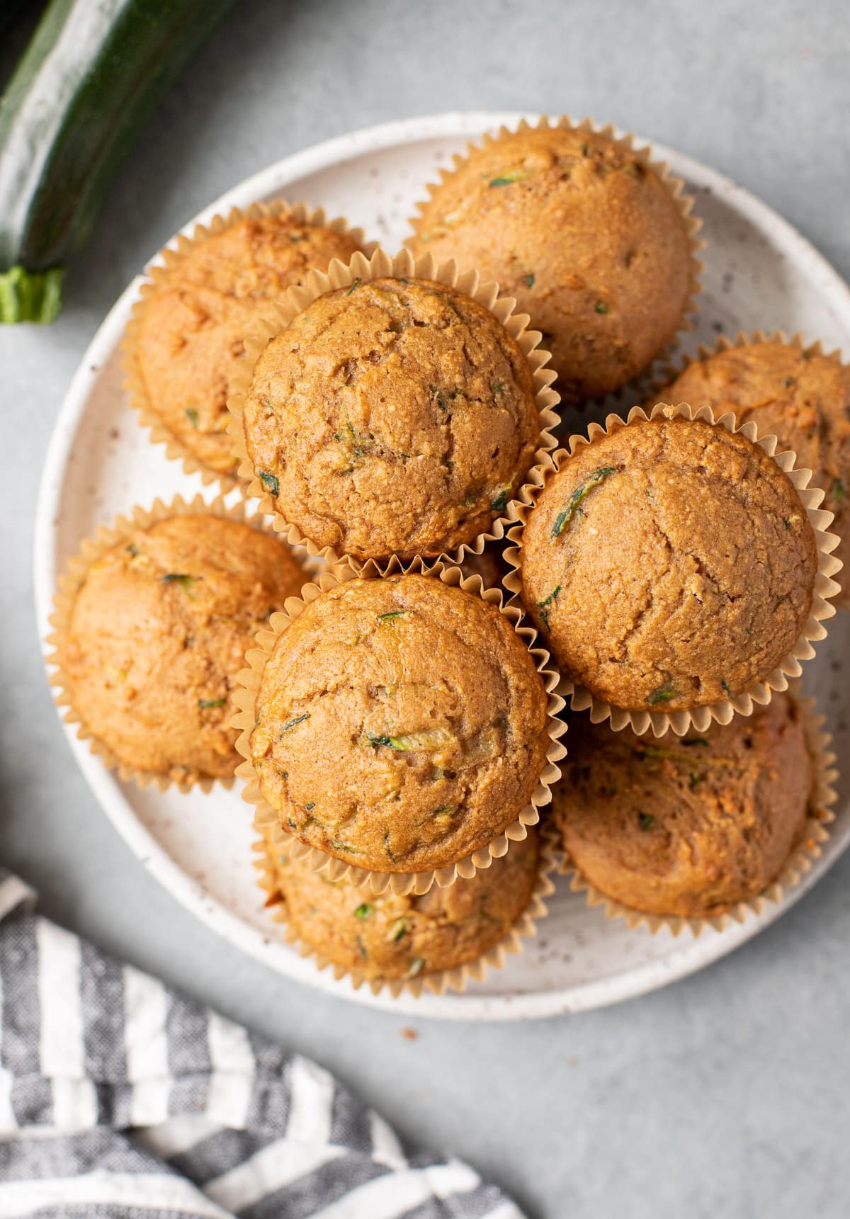 Healthy Zucchini Muffins on a white plate on a grey background