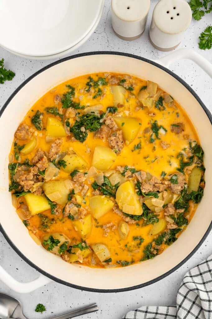 Healthy Zuppa Toscana Soup in a dutch oven on a white counter
