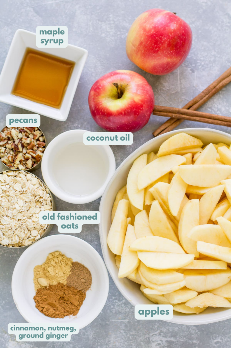 Ingredients for Healthy Apple Crisp laid out in separate bowls on a grey background