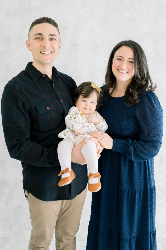 a close up of tyler marino and liz marino with their daughter