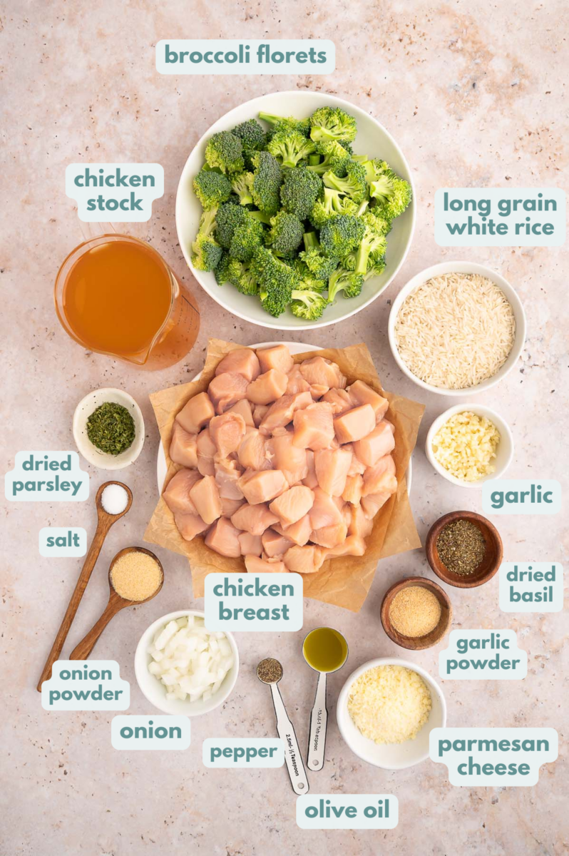 Chicken Broccoli Rice ingredients in small bowls: olive oil, boneless, skinless chicken breasts, onion, garlic, long grain white rice, broccoli, chicken stock, dried basil, dried parsley, garlic powder, onion powder, salt, pepper, parmesan cheese