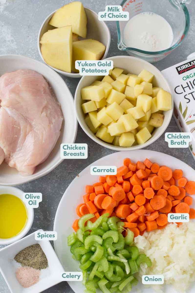 Ingredients for Healthy Chicken Pot Pie Soup laid out in small bowls on a grey background.